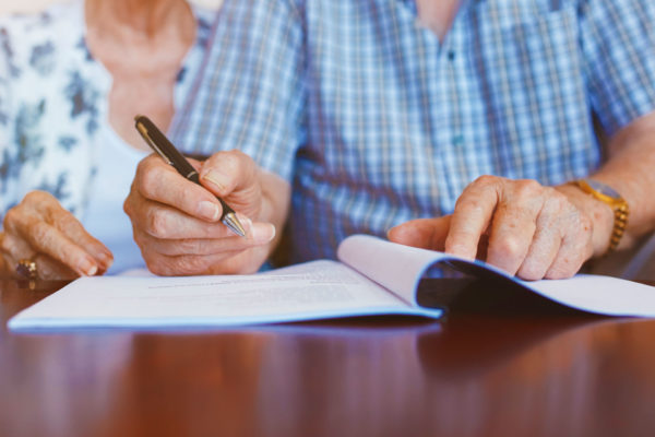 Married couple checks the details of their will for any loopholes in their estate planning strategy