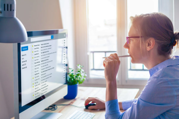 Woman checking her email for any potential legally binding contracts