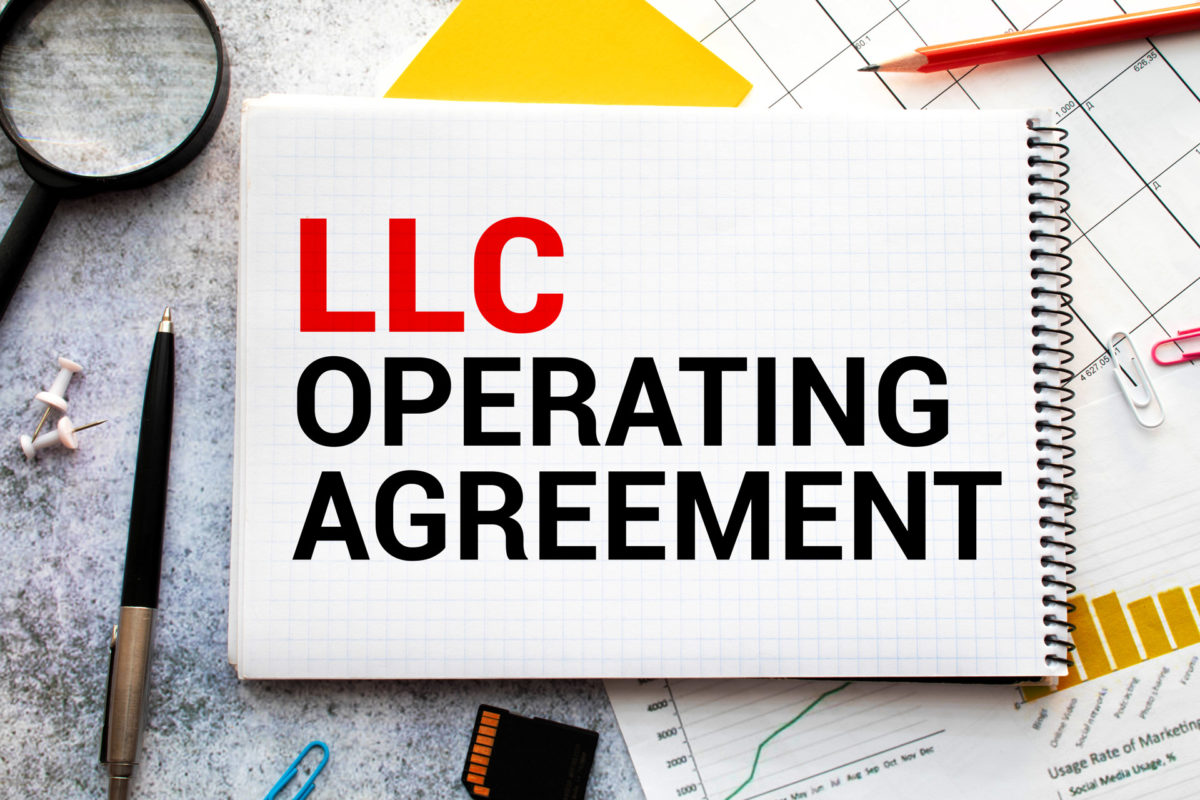 Document on top of a messy desk titled LLC Operating Agreement
