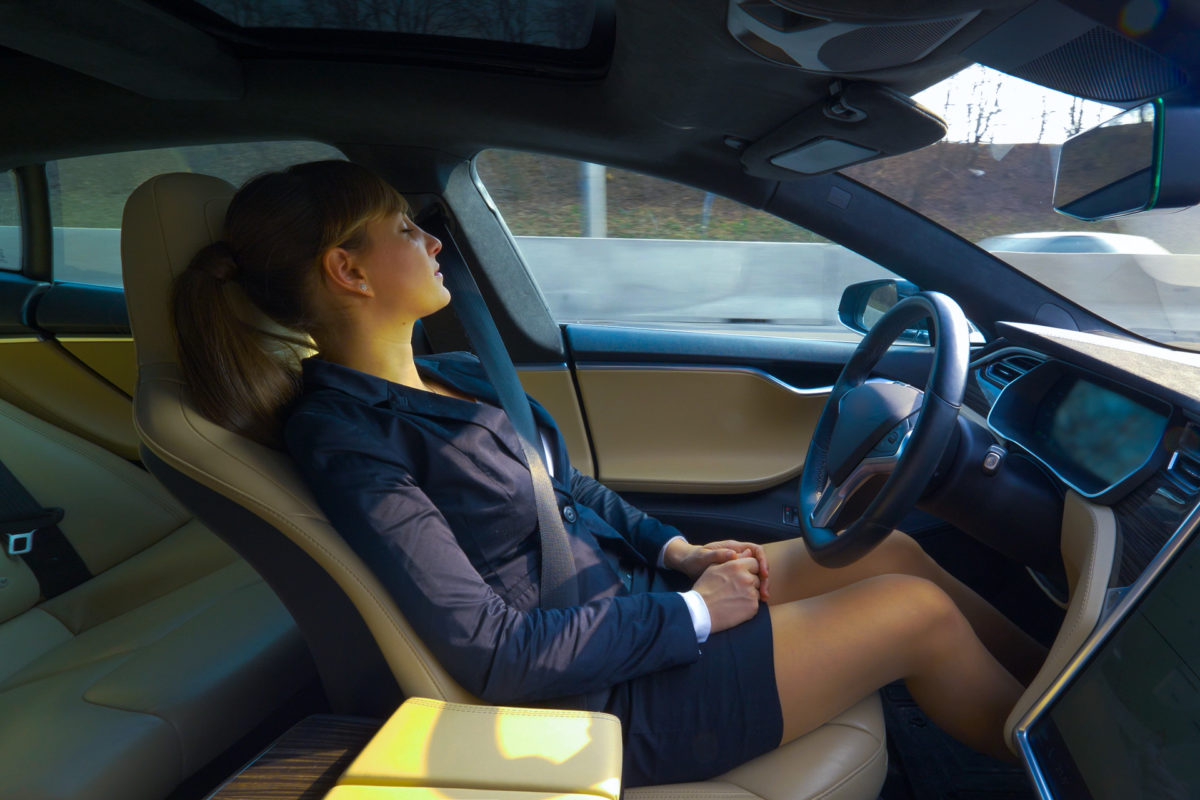 Woman sleeps during traffic in self-driving, autonomous car