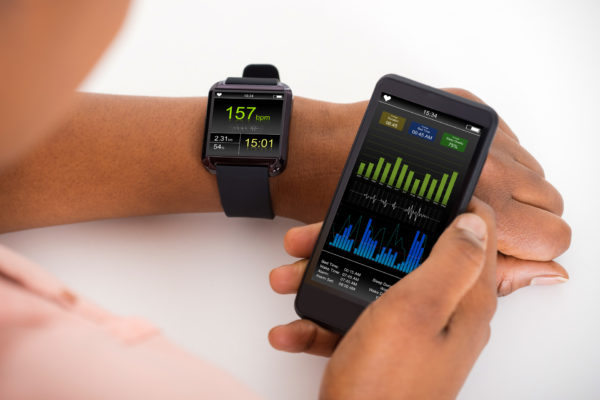 Person syncs their wearable tech, smartwatch to their smartphone