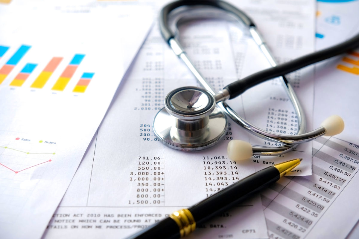 documents on a desk explaining small business requirements to follow affordable care act guidelines