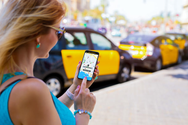 Woman hailing a ride-sharing driver