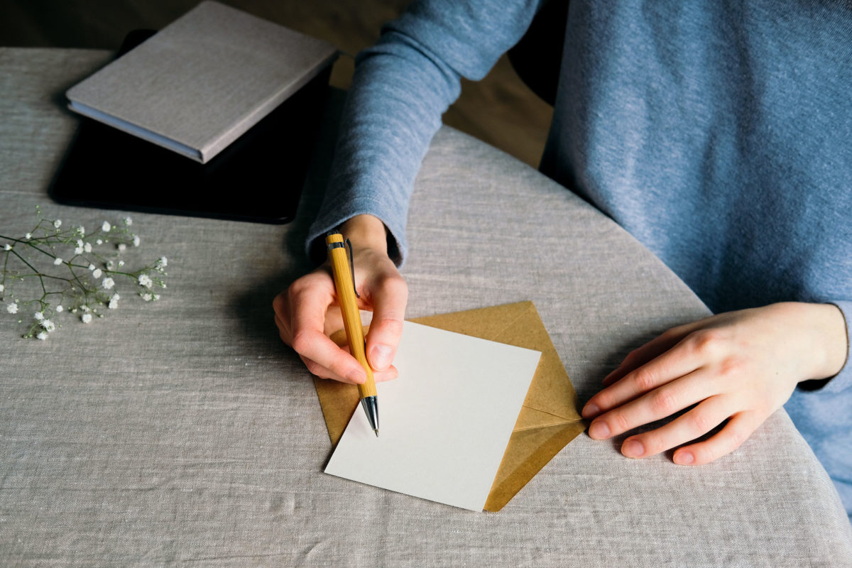 Woman writing letter or card to her loved ones