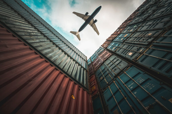 Plane flies overhead a city indicating a business venture overseas