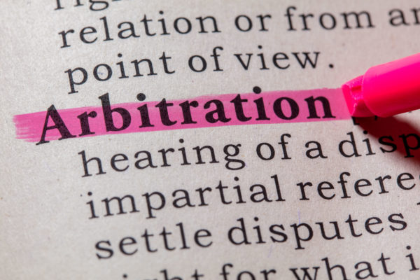 someone highlighting section in the dictionary defining arbitration