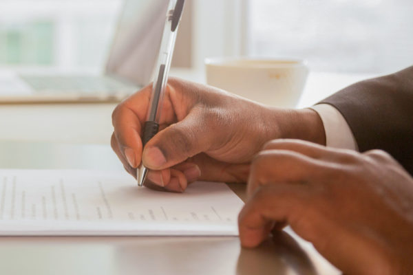 small business owner and lawyer sign a written contract