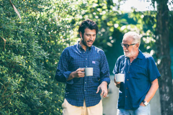 young man discusses estate planning with his elderly parent