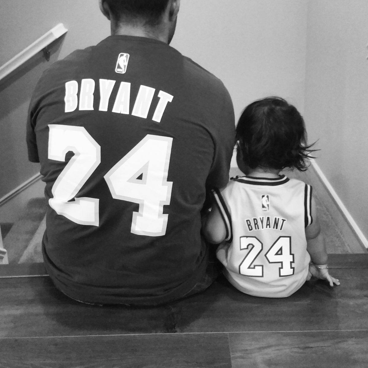 father and daughter wearing matching kobe bryant basketball jerseys