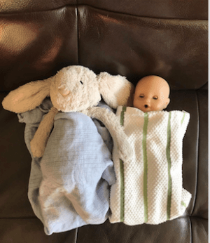 toy bunny next to baby doll