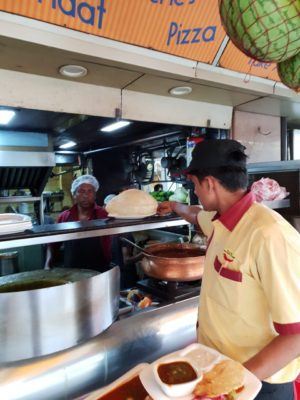 waiter taking order from kitchen staff at restaurant