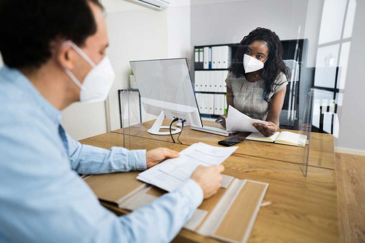 attorney and client meeting while wearing masks and social distancing