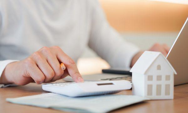 man doing property tax paperwork on laptop