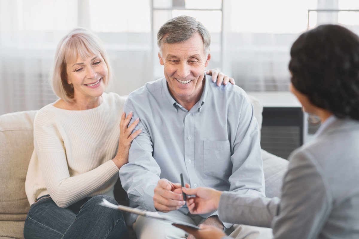 senior couple talking to financial planner