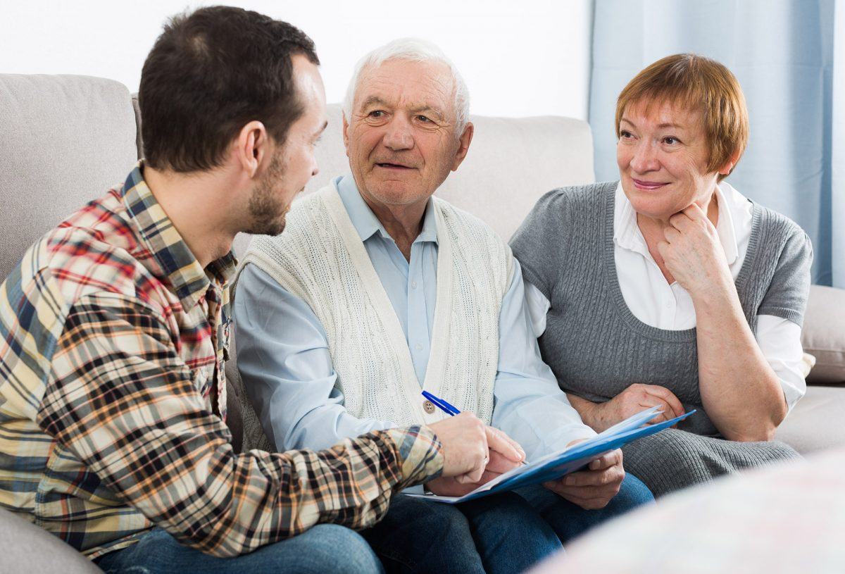 senior couple and insurance agent