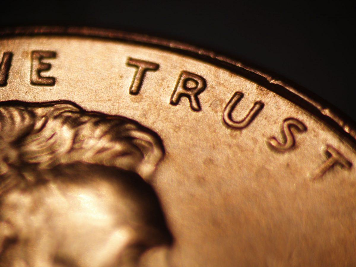 close-up photo of penny isolating the word trust