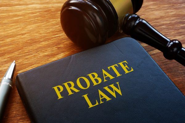 probate law book on table with gavel and pen
